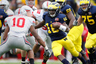 ANN ARBOR, MI - NOVEMBER 26: Denard Robinson #16 of the Michigan Wolverines tries to get around the tackle of Ryan Shazier #10 of the Ohio State Buckeyes at Michigan Stadium on November 26, 2025 in Ann Arbor, Michigan. Michigan won the game 40-34. (Photo by Gregory Shamus/Getty Images)
