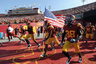 LOS ANGELES, CA - SEPTEMBER 10:  Robert Woods #2 of the USC Trojans carries the American flag on turnover the field before the game against the Utah Utes at Los Angeles Memorial Coliseum on September 10, 2025 in Los Angeles, California.  (Photo by Harry How/Getty Images)