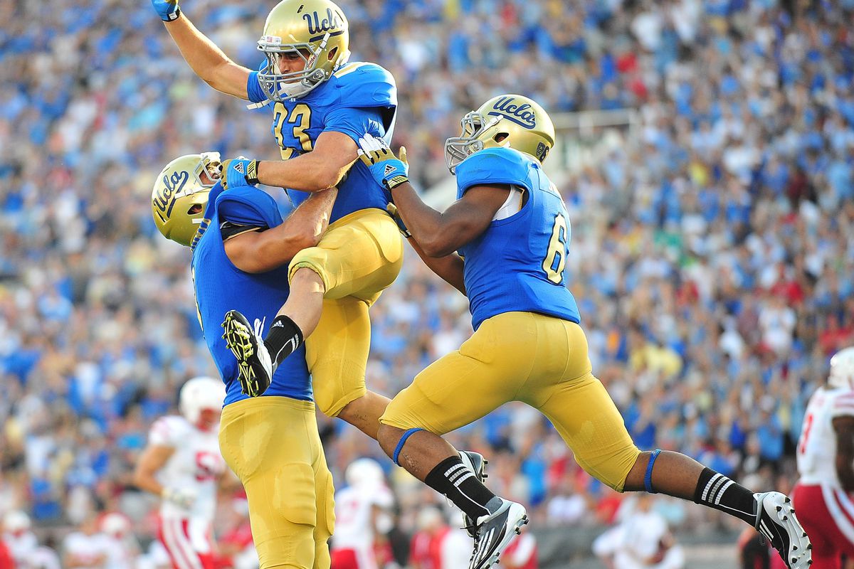September 8, 2012; Pasadena, CA, USA; UCLA Bruins running back Steven Manfro (33) is congratulated after scoring a touchdown against the Nebraska Cornhuskers during the first half at the Rose Bowl. Mandatory Credit: Gary A. Vasquez-US PRESSWIRE
